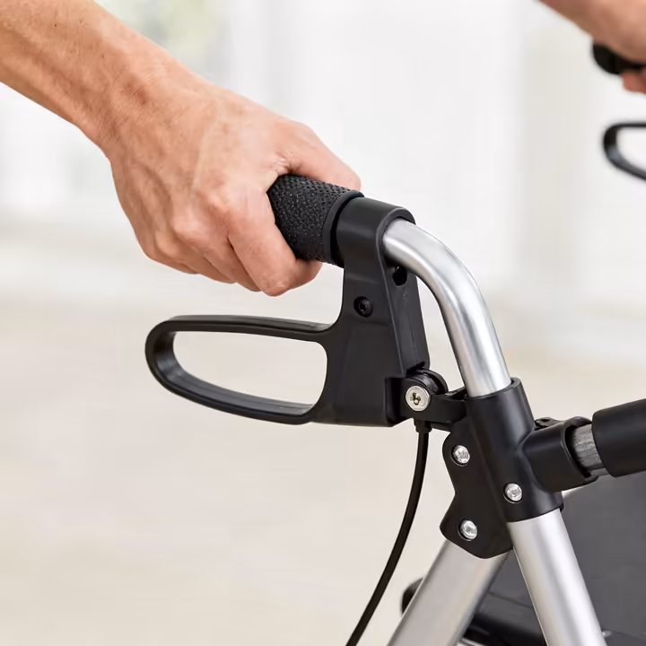 A close-up view of a rollator walker's loop-style hand brake, showing the locked and unlocked positions.